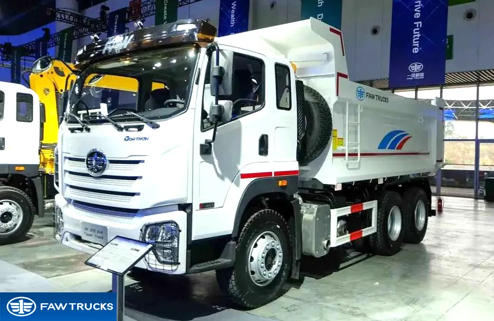 White DORTRON DK 320 6x4 dump truck displayed at an exhibition, featuring FAW branding and a heavy-duty tipper configuration.