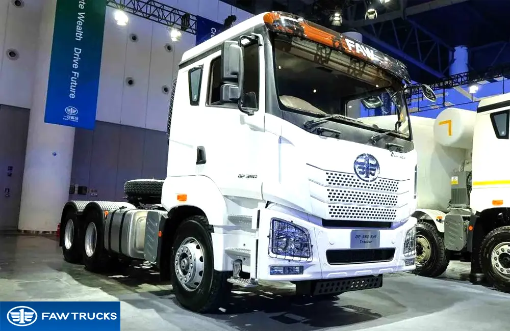 White DORTRON DP 390 6x4 tractor truck displayed at an exhibition, featuring FAW Jiefang branding and a 6x4 heavy-duty truck configuration.