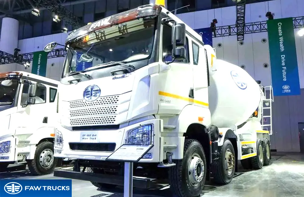 White DORTRON DP 460 8x4 concrete mixer truck displayed at an exhibition, featuring FAW branding and a heavy-duty mixer configuration.