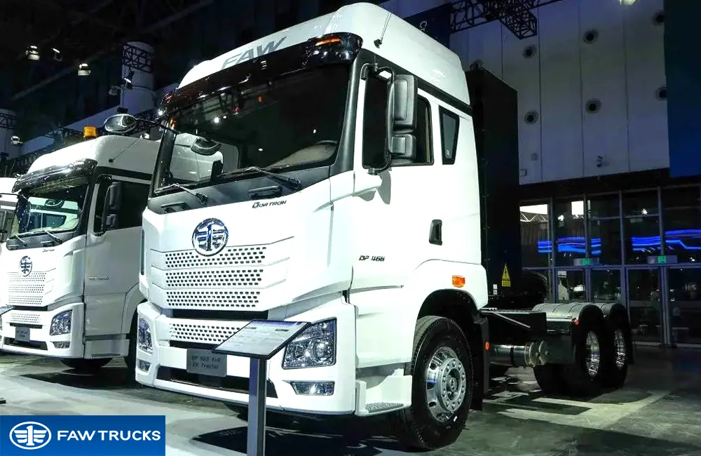 White DORTRON DP 466 6x4 battery electric tractor truck displayed at an exhibition, featuring FAW branding and a heavy-duty electric tractor configuration.