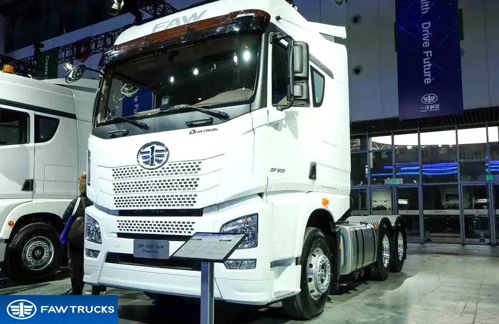 White DORTRON DP 500 6x4 tractor truck displayed at an exhibition, featuring FAW branding and a 6x4 heavy-duty tractor configuration.