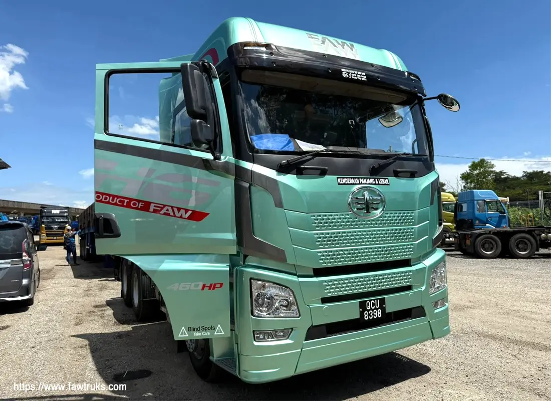 Mint green FAW JH6 460HP truck with driver door open