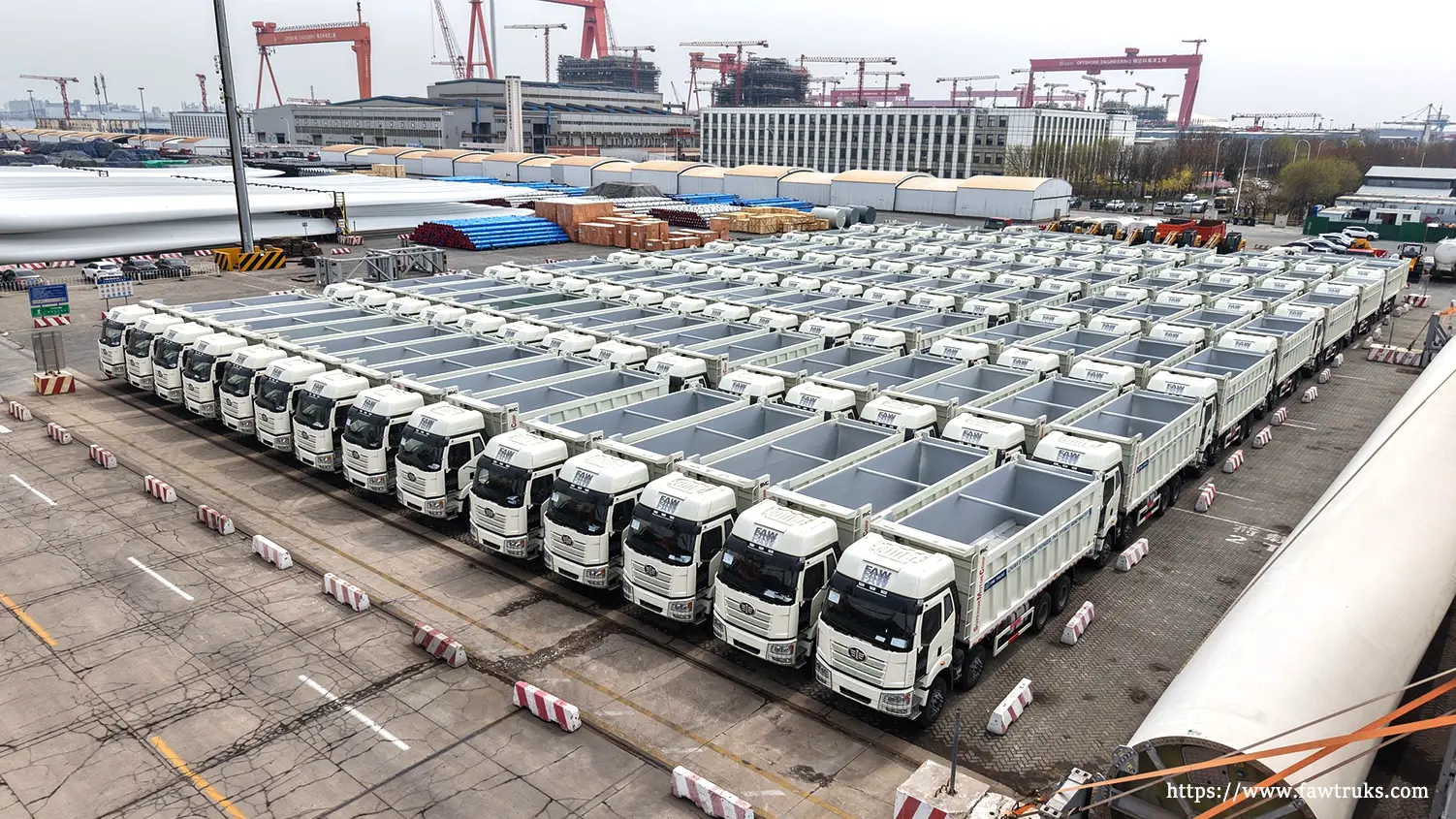 Row of FAW trucks parked at port ready for export to Indonesia