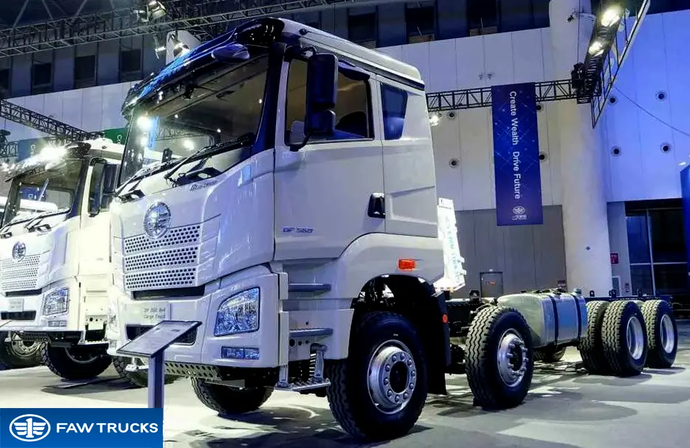 White DORTRON DP 560 8x4 cargo truck chassis displayed at an exhibition, featuring FAW branding and a heavy-duty multi-axle chassis configuration.