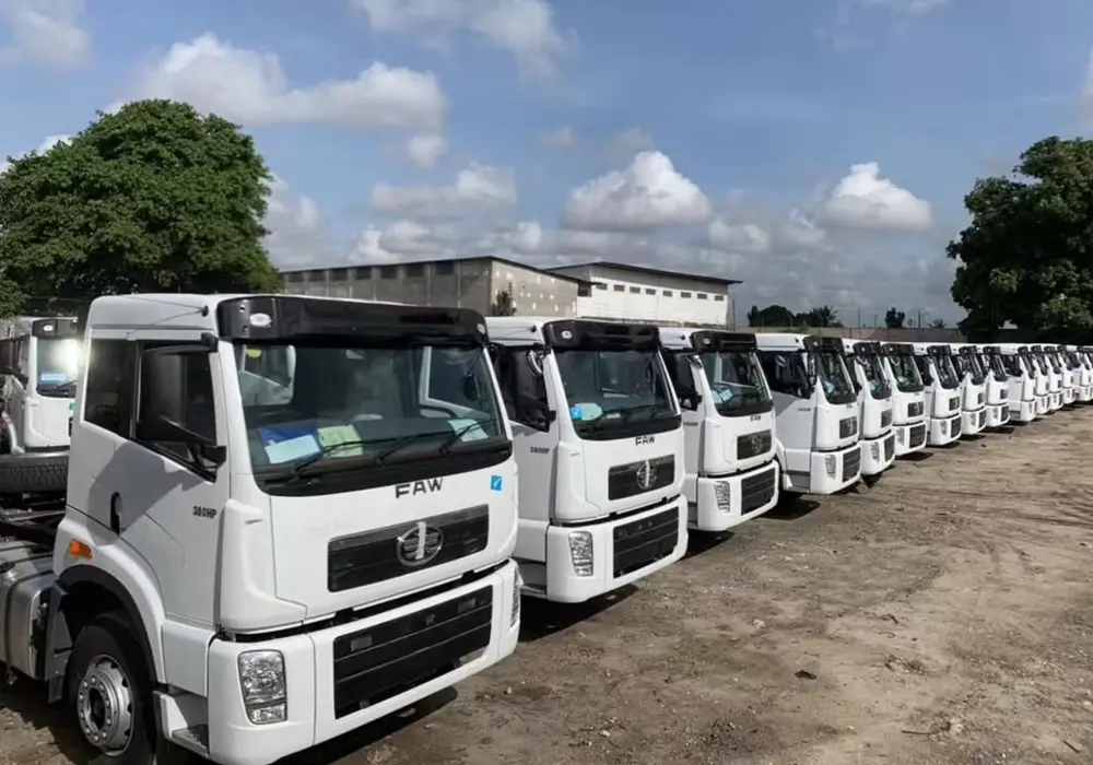 Mechanic inspecting a used FAW truck in Tanzania